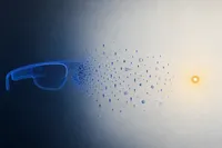 Silueta de unas gafas inteligentes en azul cobalto que se deshace en partículas que migran hacia un nodo ámbar.